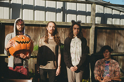 Group photo of san francisco experimental pop band real real talk with a pumpkin